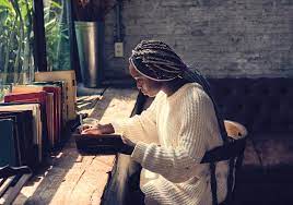 Image of a woman journaling at her desk