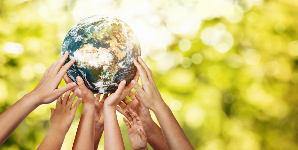 Image of hands holding up picture of globe