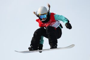 Female snowboarder in winter Olympics in inspirational jump