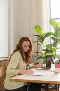 A woman sitting at the desk working to signify carrying the mental load