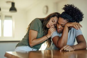 Women sitting together to symbolise identifying toxic positivity