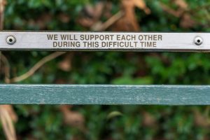 Plaque that says 'we will support each other' to symbolise coping with uncertainty
