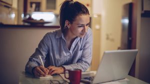 Image of a woman working at her computer to ask does coaching work