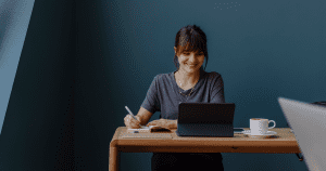 Image of woman smiling at her computer to signify does coaching work