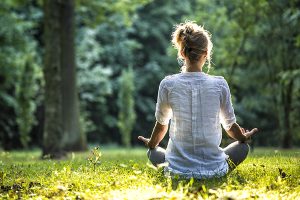 Woman meditating in a field