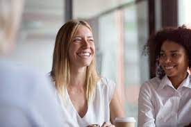 Image of woman laughing past the camera 