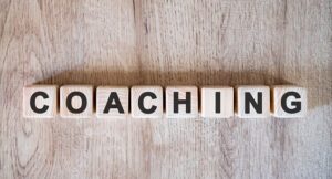 Domino tiles that spell 'coaching'