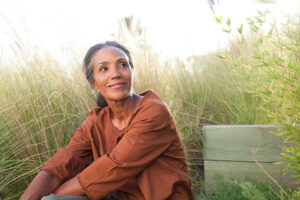 Middle-aged woman smiling to represent empty nest syndrome