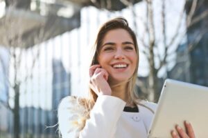 Woman on the phone smiling into the distance