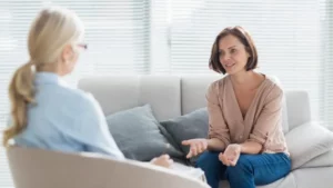 Woman sitting on a sofa talking to a life coach
