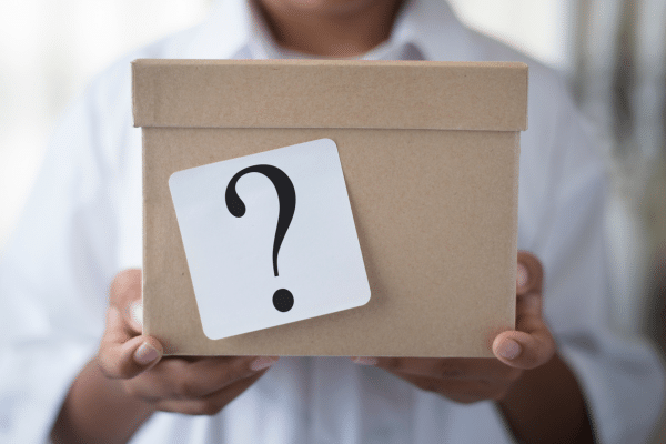 Person holding a box with a question mark on it