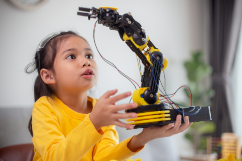 Image of a child playing with robotic toy to demonstrate giftedness
