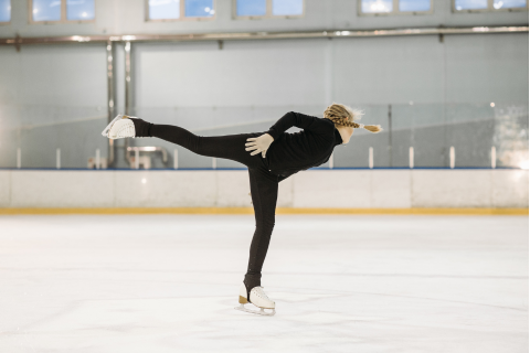 Female athlete practicing figure skating for Olympics
