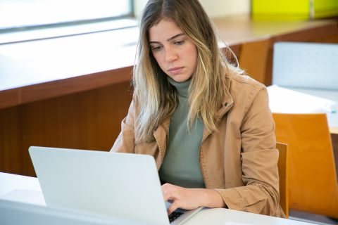 Woman in library looking at computer